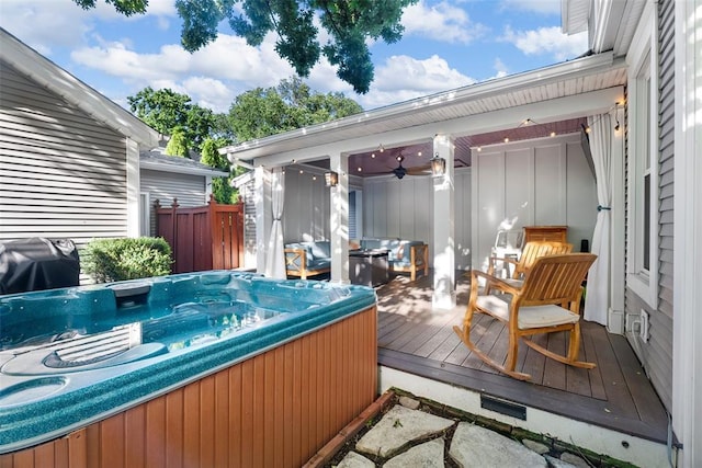 deck with a hot tub, a grill, and ceiling fan