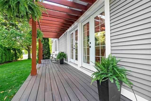 wooden deck with french doors and a lawn