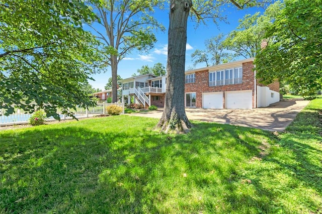 10014 Aldred Dr, Sunset Hills, MO 63128 - back of property featuring brick siding, stairway, an attached garage, a chimney, and concrete driveway