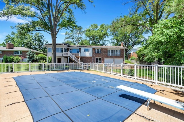 10014 Aldred Dr, Sunset Hills, MO 63128 - view of swimming pool with a diving board and stairway