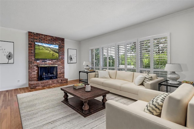 10014 Aldred Dr, Sunset Hills, MO 63128 - living room featuring ornamental molding, wood finished floors, a fireplace, a textured ceiling, and baseboards