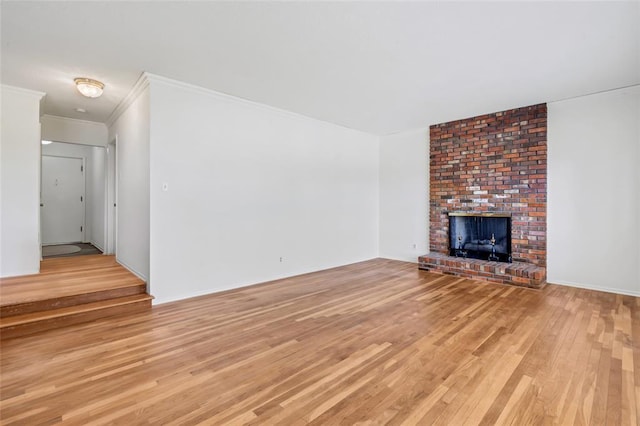 10014 Aldred Dr, Sunset Hills, MO 63128 - unfurnished living room with light wood-type flooring, a fireplace, and ornamental molding