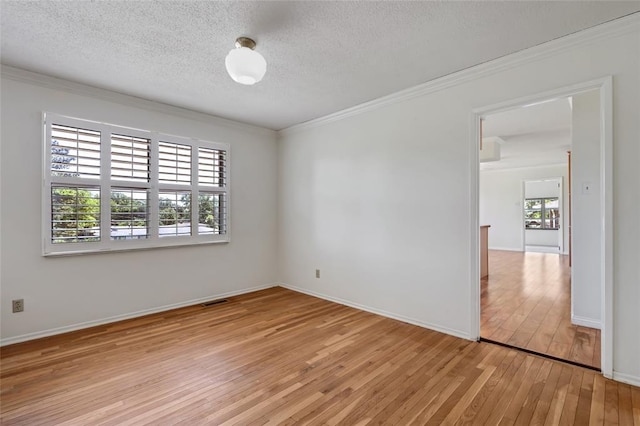 10014 Aldred Dr, Sunset Hills, MO 63128 - spare room with light wood-type flooring, ornamental molding, a textured ceiling, and baseboards