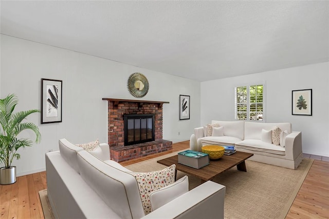 10014 Aldred Dr, Sunset Hills, MO 63128 - living area featuring light wood-style floors, a fireplace, and baseboards