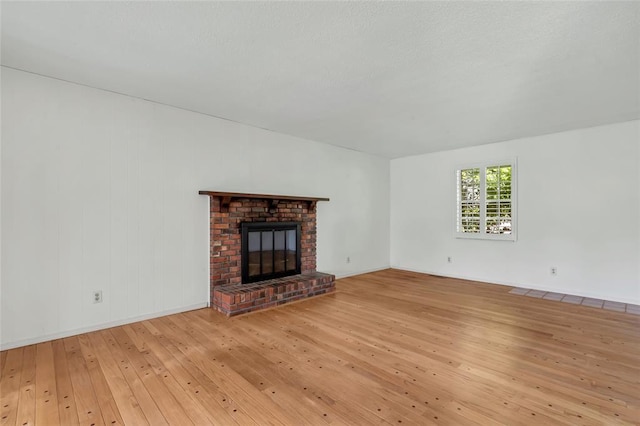 10014 Aldred Dr, Sunset Hills, MO 63128 - unfurnished living room featuring wood-type flooring, a fireplace, and baseboards