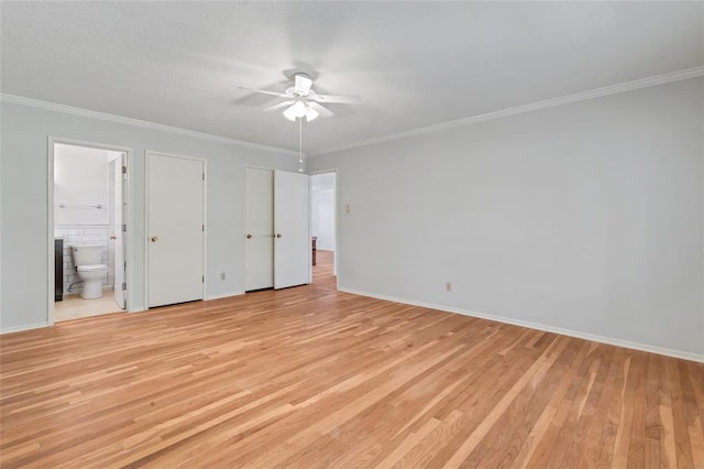 10014 Aldred Dr, Sunset Hills, MO 63128 - unfurnished bedroom with light wood-style floors, ensuite bathroom, baseboards, crown molding, and two closets