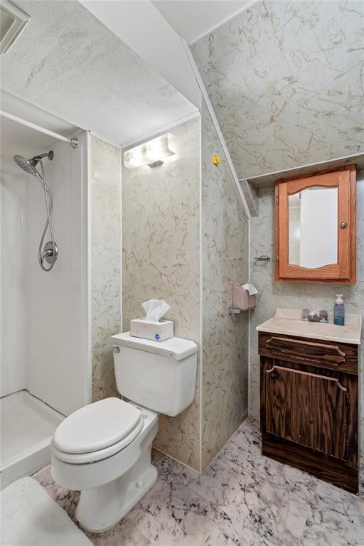 10014 Aldred Dr, Sunset Hills, MO 63128 - bathroom with toilet, vanity, a shower, and marble finish flooring
