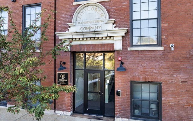 property entrance featuring brick siding