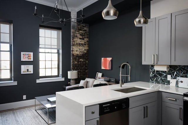 kitchen with dishwasher, a sink, gray cabinetry, a peninsula, and light countertops