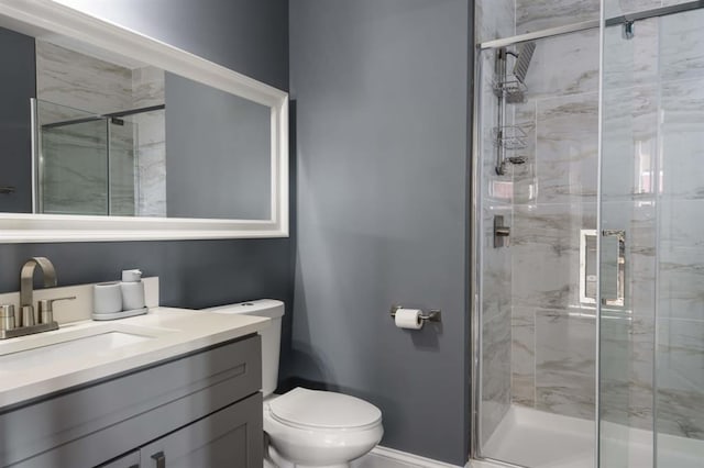full bathroom featuring a stall shower, toilet, and vanity