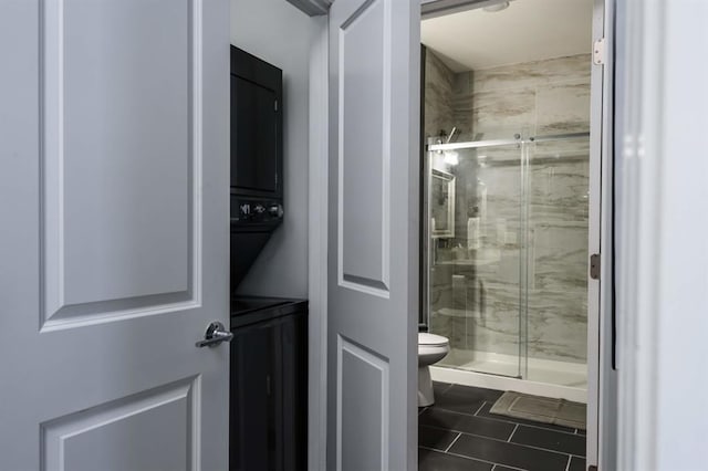full bathroom with toilet, a shower stall, and tile patterned floors