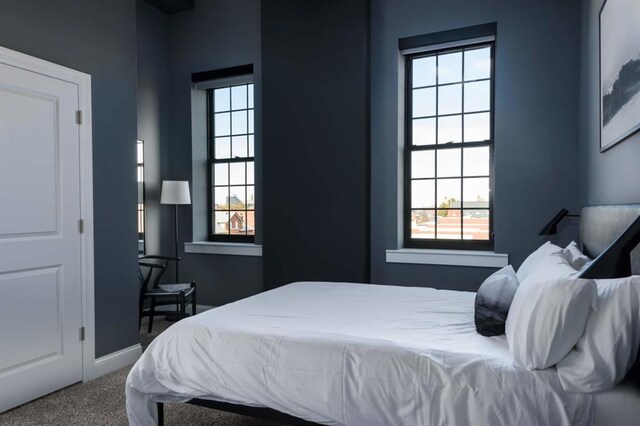 carpeted bedroom with baseboards