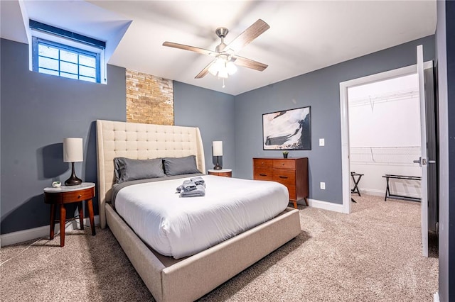 carpeted bedroom featuring baseboards and a ceiling fan