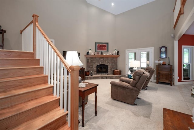 5193 Athlone Ct, Cedar Hill, MO 63016 - carpeted living area featuring a high ceiling, stairs, plenty of natural light, a stone fireplace, and baseboards