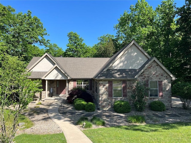 view of front facade with stone siding, a shingled roof, and a porch