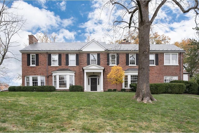 15 Briarcliff Rd, Ladue, MO 63124 - view of front of property featuring a chimney, a front lawn, and brick siding