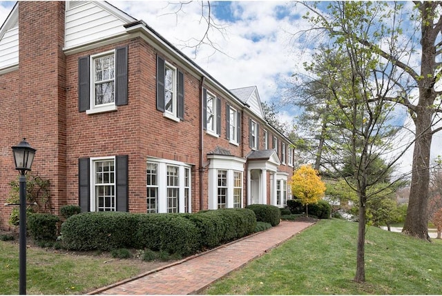 15 Briarcliff Rd, Ladue, MO 63124 - view of side of home featuring brick siding, a yard, and a chimney