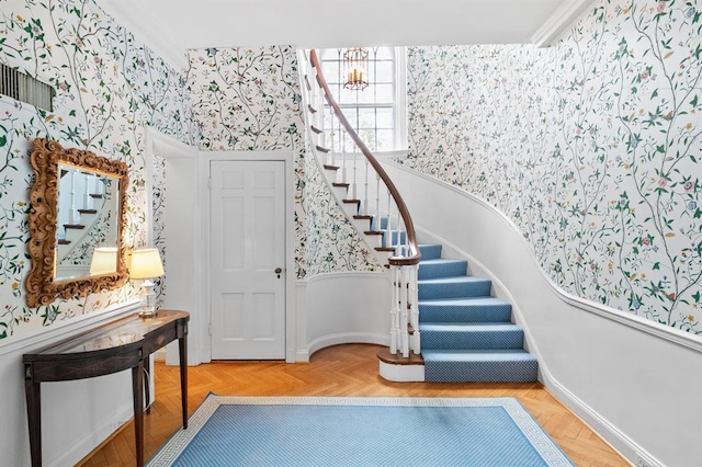 15 Briarcliff Rd, Ladue, MO 63124 - entrance foyer featuring wallpapered walls, stairway, and baseboards