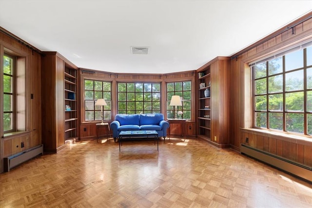 15 Briarcliff Rd, Ladue, MO 63124 - living area with a baseboard heating unit, built in features, and wooden walls