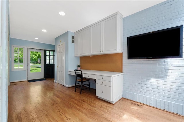 15 Briarcliff Rd, Ladue, MO 63124 - unfurnished office featuring built in study area, light wood finished floors, baseboards, recessed lighting, and brick wall