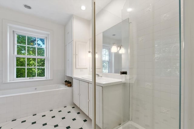 15 Briarcliff Rd, Ladue, MO 63124 - full bath with vanity, tiled shower, and a garden tub