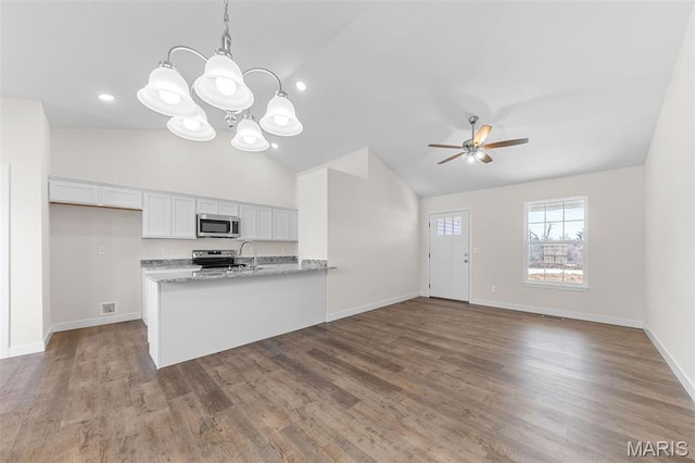 280 Railroad St, Moscow Mills, MO 63362 - kitchen with stainless steel appliances, lofted ceiling, white cabinets, a chandelier, and a ceiling fan