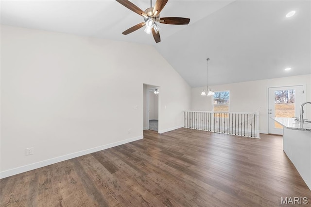 280 Railroad St, Moscow Mills, MO 63362 - unfurnished living room featuring a ceiling fan, a chandelier, vaulted ceiling, dark wood-type flooring, and recessed lighting