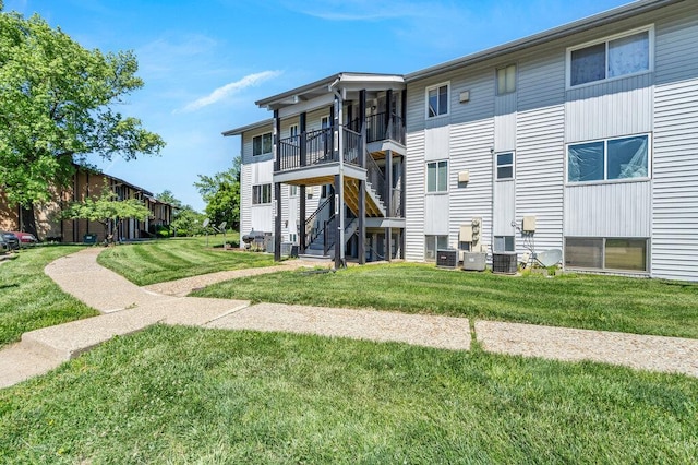 1843 Gascony Parc Dr Unit 1843, Lake St Louis, MO 63367 - rear view of property featuring a yard, a balcony, and central AC unit