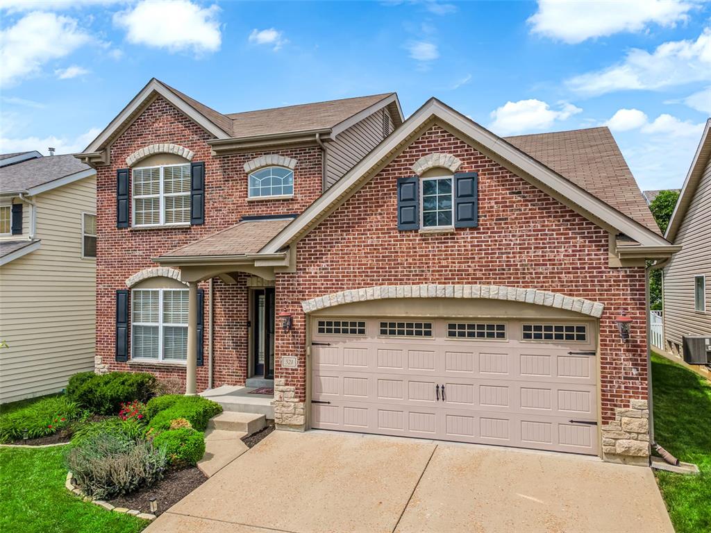 521 Newkirk Cir, Saint Charles, MO 63303 - traditional-style house with brick siding, driveway, a shingled roof, and cooling unit