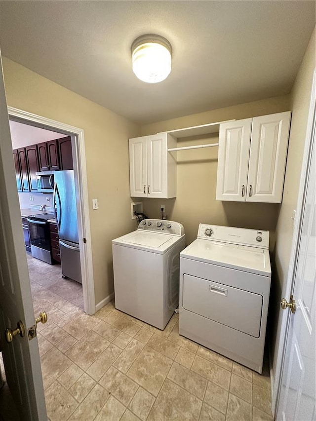 laundry room featuring cabinet space and separate washer and dryer