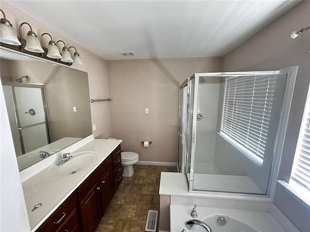 full bath with a shower stall, vanity, toilet, and baseboards