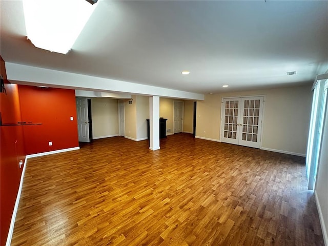 empty room with wood finished floors, baseboards, and recessed lighting