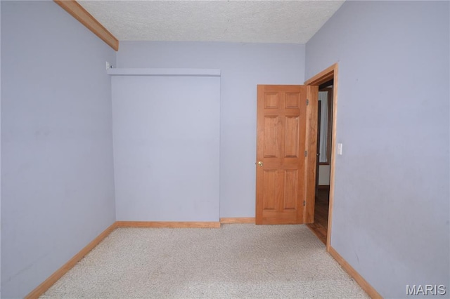 11370 County Road 5220, Rolla, MO 65401 - spare room featuring carpet flooring and a textured ceiling