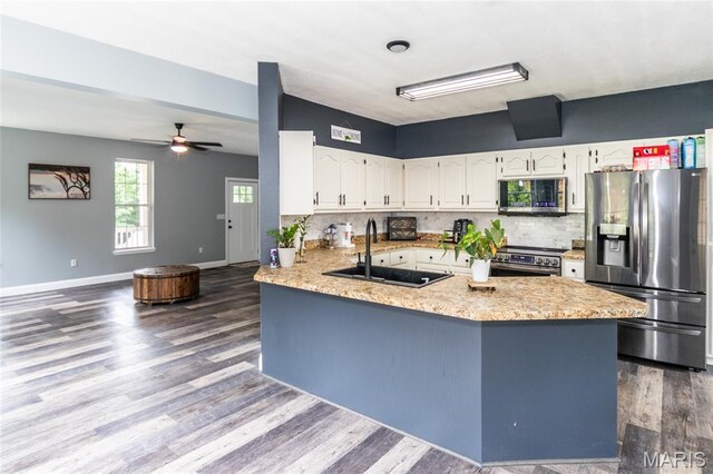 7011 Browns Ford Rd, Dittmer, MO 63023 - kitchen with stainless steel appliances, dark wood-style floors, white cabinets, and a peninsula