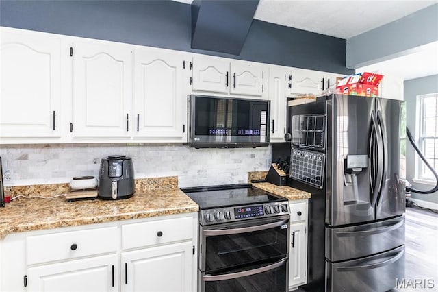 7011 Browns Ford Rd, Dittmer, MO 63023 - kitchen featuring appliances with stainless steel finishes, white cabinets, and backsplash