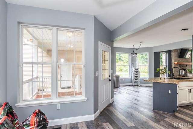 7011 Browns Ford Rd, Dittmer, MO 63023 - kitchen featuring dark wood-type flooring, white cabinetry, light stone counters, lofted ceiling, and pendant lighting