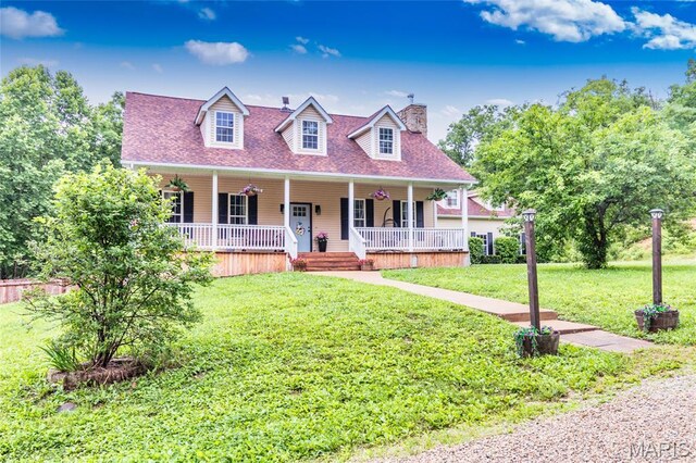 7011 Browns Ford Rd, Dittmer, MO 63023 - cape cod house featuring covered porch, a front lawn, a chimney, and roof with shingles