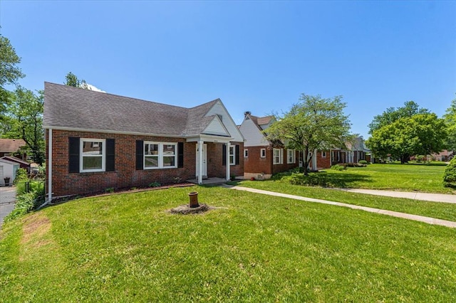 8908 Apache Ln, Overland, MO 63114 - view of front of property featuring a front yard, brick siding, and a shingled roof