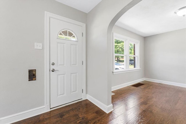 8908 Apache Ln, Overland, MO 63114 - foyer entrance featuring arched walkways, wood finished floors, and baseboards