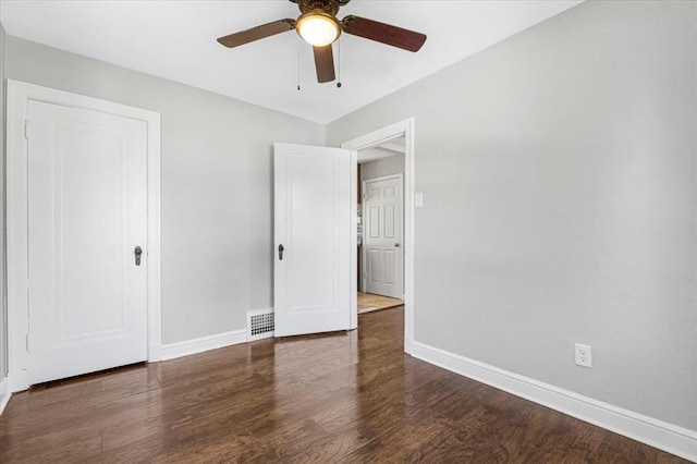 8908 Apache Ln, Overland, MO 63114 - unfurnished bedroom featuring baseboards, wood finished floors, and a ceiling fan