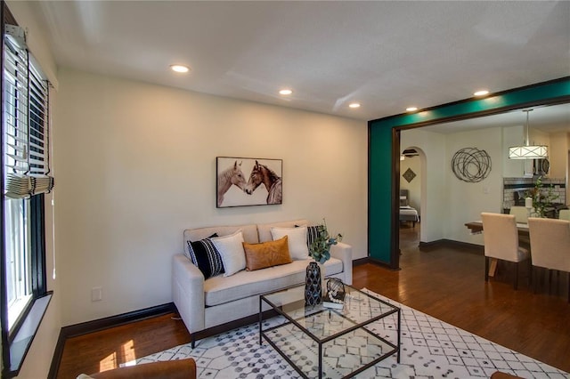 1104 Douglas St, Alton, IL 62002 - living room with wood finished floors, arched walkways, baseboards, and recessed lighting