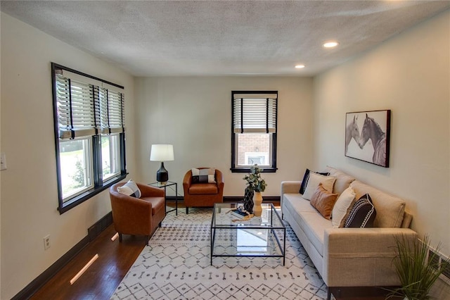 1104 Douglas St, Alton, IL 62002 - living area featuring wood finished floors, baseboards, recessed lighting, and a textured ceiling