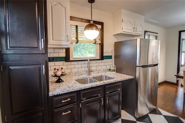 1104 Douglas St, Alton, IL 62002 - kitchen featuring a sink, freestanding refrigerator, white cabinets, backsplash, and baseboards