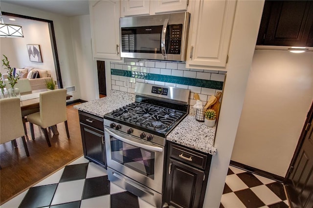 1104 Douglas St, Alton, IL 62002 - kitchen with stainless steel appliances, tile patterned floors, white cabinetry, and decorative backsplash