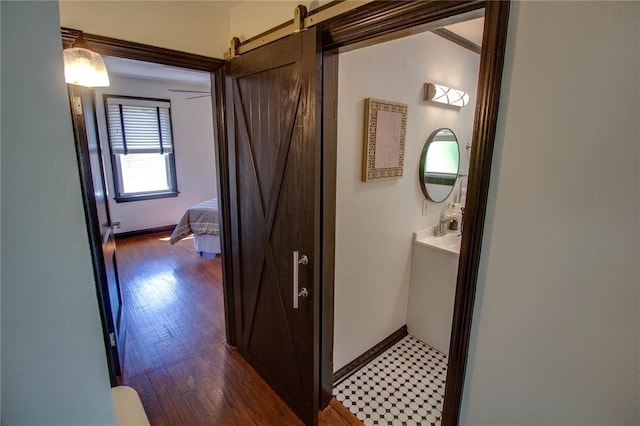 1104 Douglas St, Alton, IL 62002 - hall with wood finished floors, a barn door, and baseboards