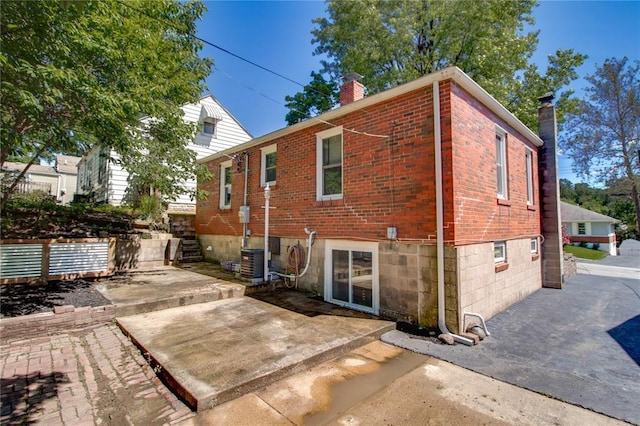 1104 Douglas St, Alton, IL 62002 - rear view of property with a chimney, brick siding, and a patio area