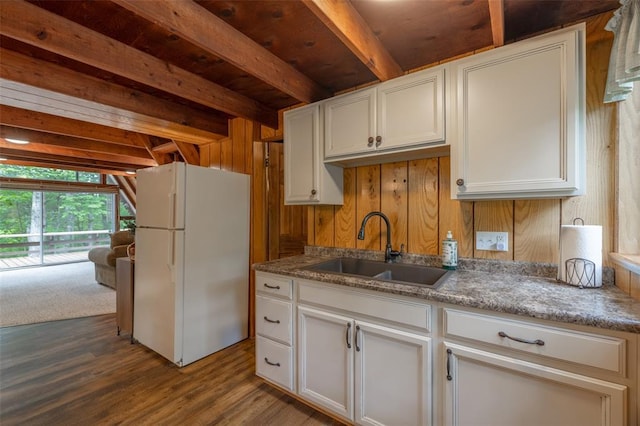 84 E Altdorf Dr, Innsbrook, MO 63390 - kitchen with freestanding refrigerator, a sink, beam ceiling, wooden walls, and dark wood-style floors