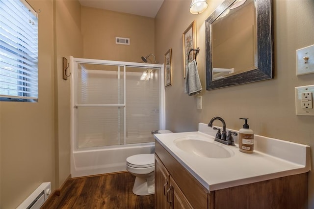 84 E Altdorf Dr, Innsbrook, MO 63390 - full bath with a baseboard radiator, vanity, toilet, wood finished floors, and bath / shower combo with glass door