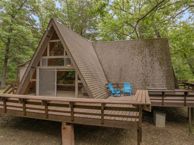 84 E Altdorf Dr, Innsbrook, MO 63390 - back of property with a deck and roof with shingles