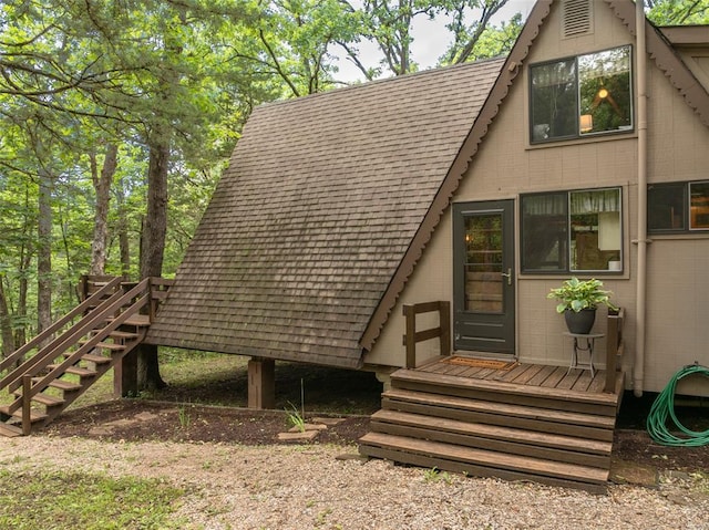 84 E Altdorf Dr, Innsbrook, MO 63390 - back of property with stairway and a shingled roof